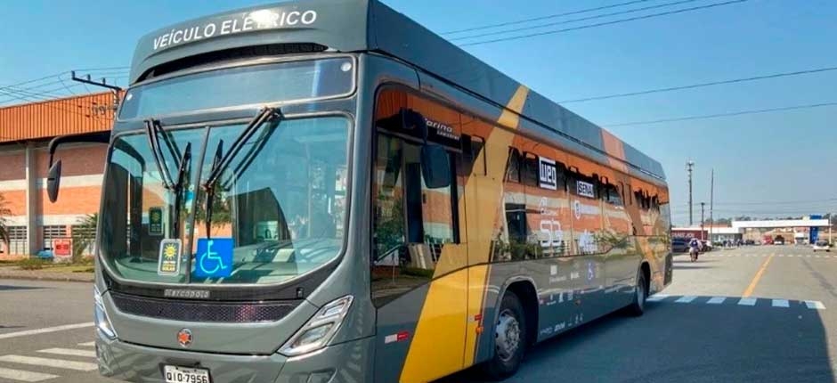 ônibus elétrico parado na rua com uma decoração de tons laranja e cinza